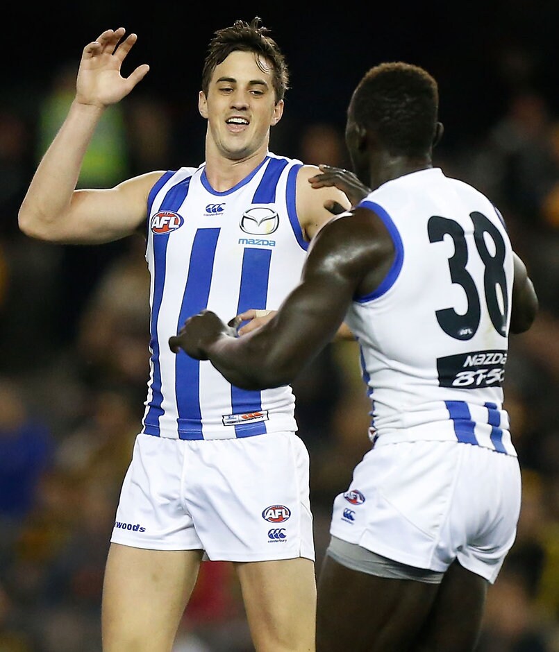 AFL 2015 Rd 23 - Richmond v North Melbourne MELBOURNE, AUSTRALIA - SEPTEMBER 4: Majak Daw of the Kangaroos (right) celebrates a goal with teammate Taylor Garner during the 2015 AFL round 23 match between the Richmond Tigers and the North Melbourne Kangaroos at Etihad Stadium, Melbourne, Australia on September 4, 2015. (Photo by Adam Trafford/AFL Media)
